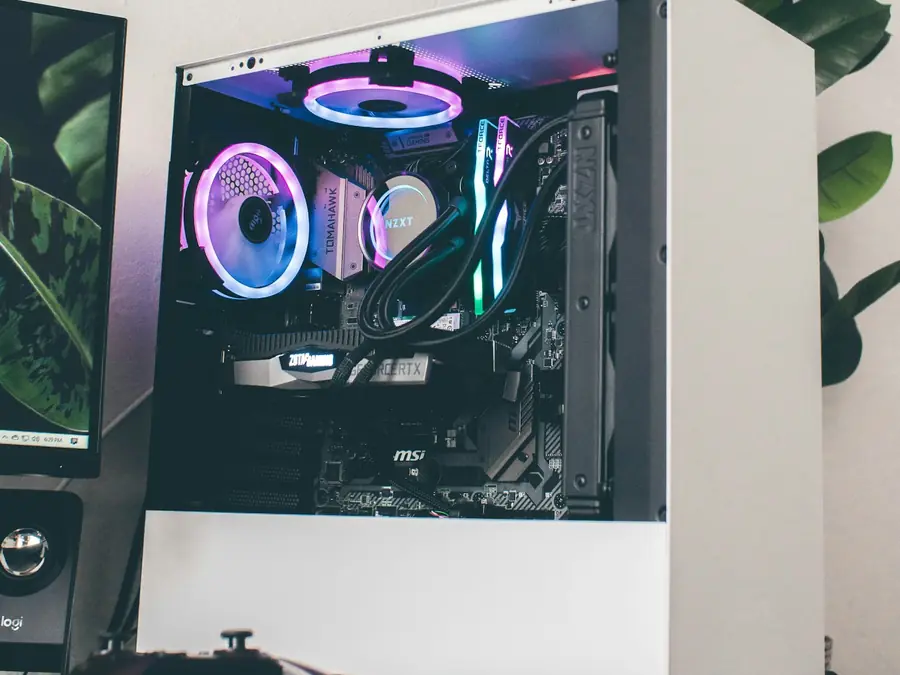 Custom-built gaming PC with lit fans inside a glass-sided case