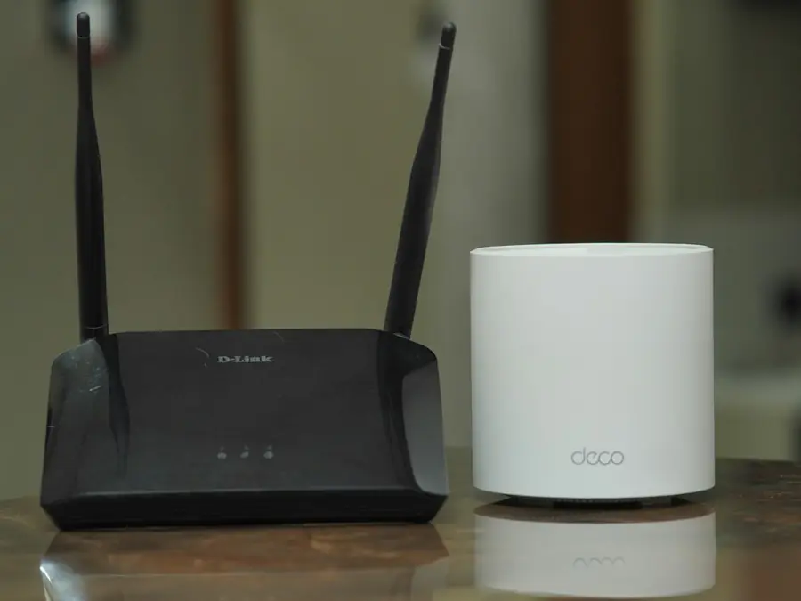 Wi-Fi router and a mesh Wi-Fi unit sitting on a table